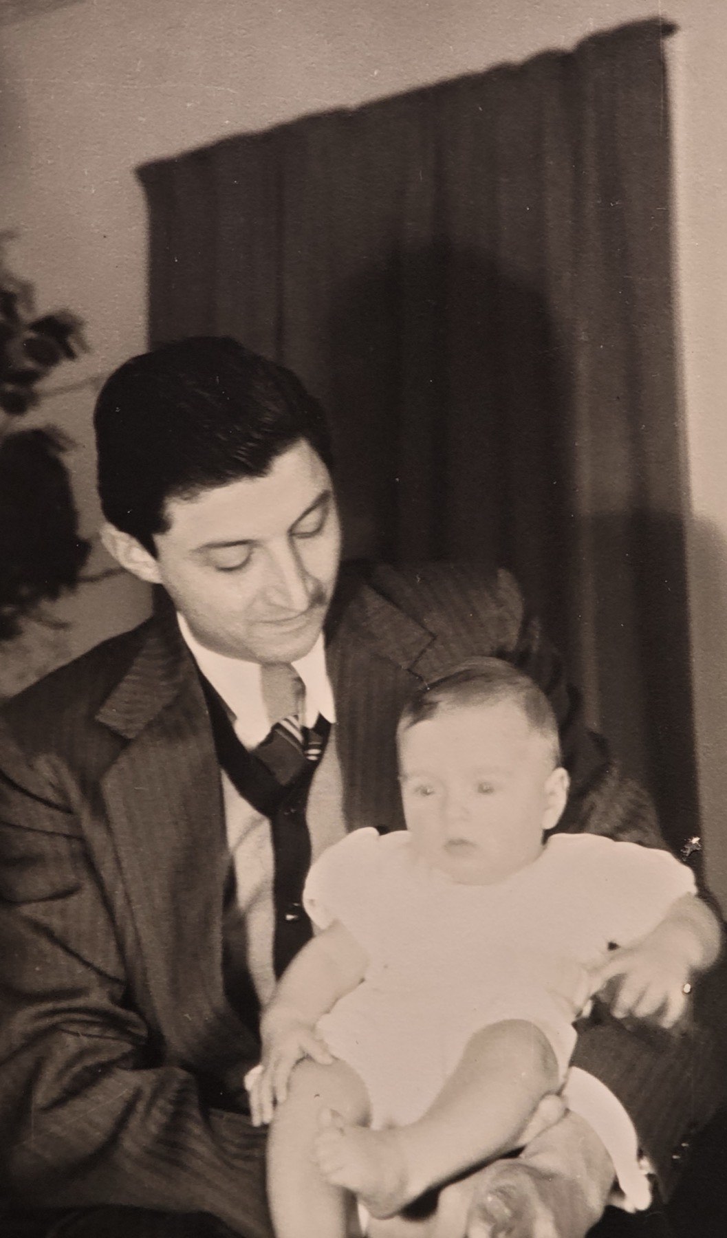 Sam holding his baby son Neville.