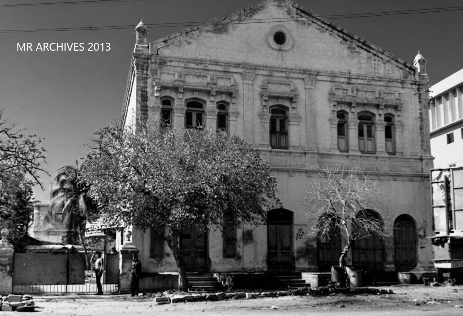 The Sequeira family house on Inverarity Road, Saddar: a large, ornate two-storey building with arched windows, behind trees.